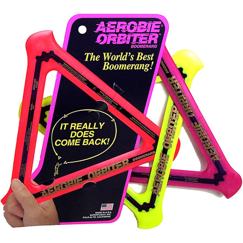 Allsports Superstore Aerobie Orbiter boomerang flying outdoors against a clear sky. Durable outdoor game equipment.