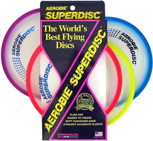 Aerobie Superdisc flying disc for outdoor games, shown in mid-air, suitable for sports and playing with dogs.