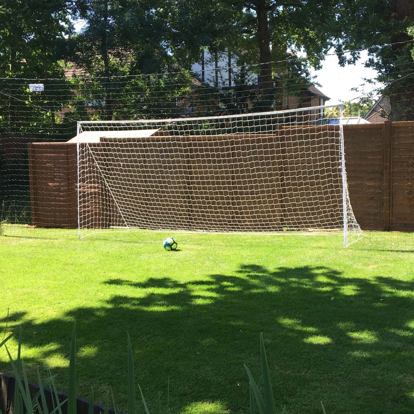 OpenGoaaal! football goal with backstop netting and rebounder for soccer practice, sporting goods equipment for training and gameplay.
