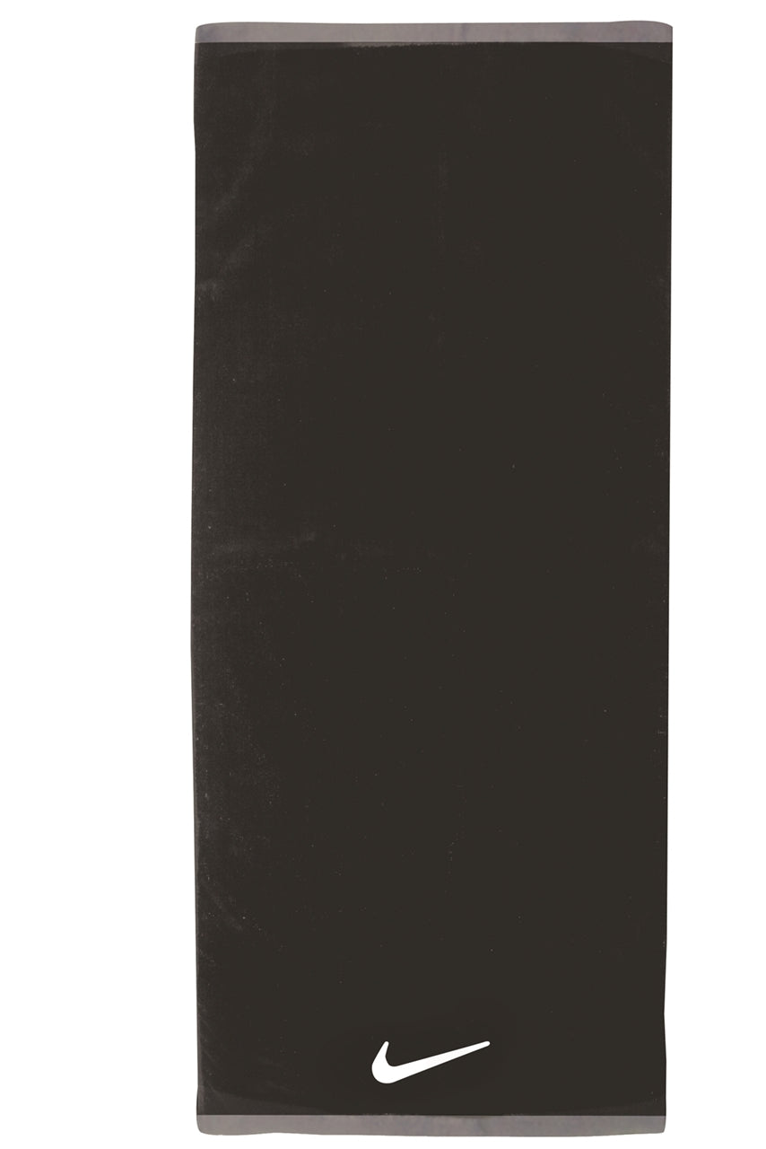 Nike Fundamental towel in white with Nike logo, made of soft cotton, shown folded with textured fabric detail.