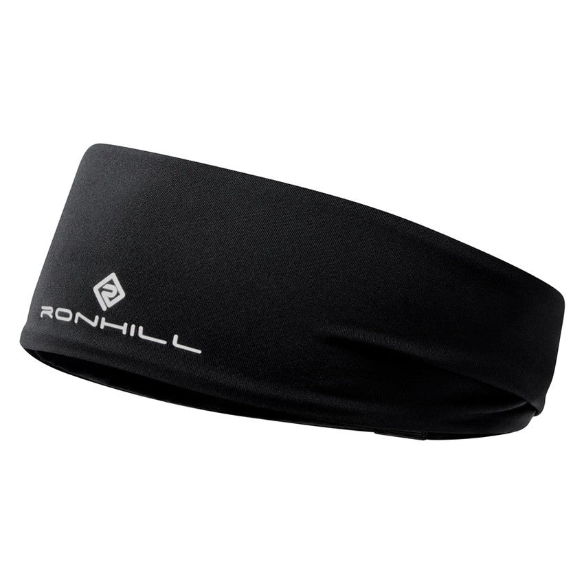 Ronhill reversible Revive headband for running, showing a lightweight, moisture-wicking sweatband with reversible design in outdoor setting.