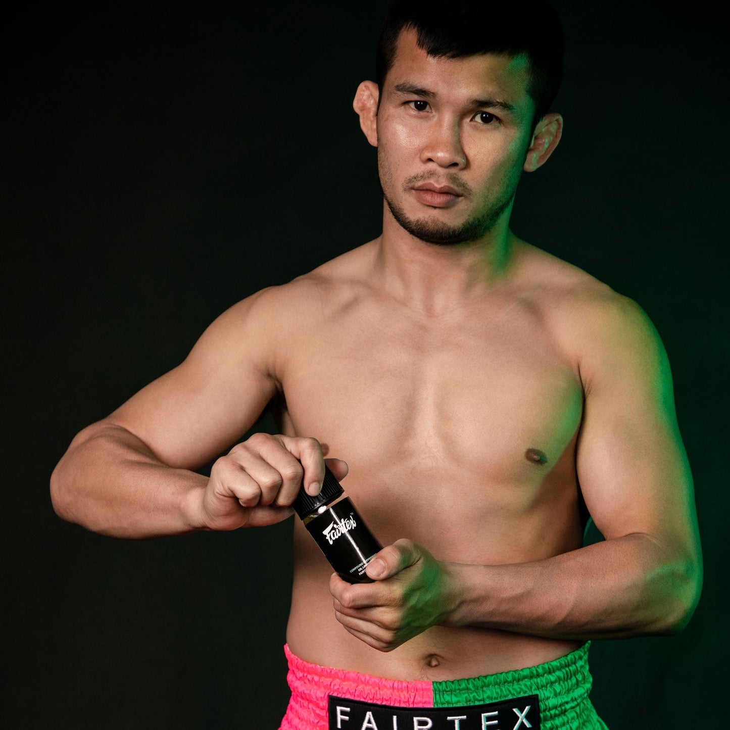 Fairtex Liniment Oil with orange scent in 100ml bottle, sporting goods product for muscle relief and soothing aromatherapy.