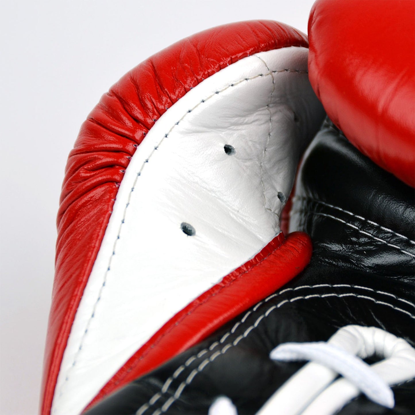 Fairtex BGL7 Mexican-style lace-up training gloves in red, black, and white with padded palms and wrist support for boxing training