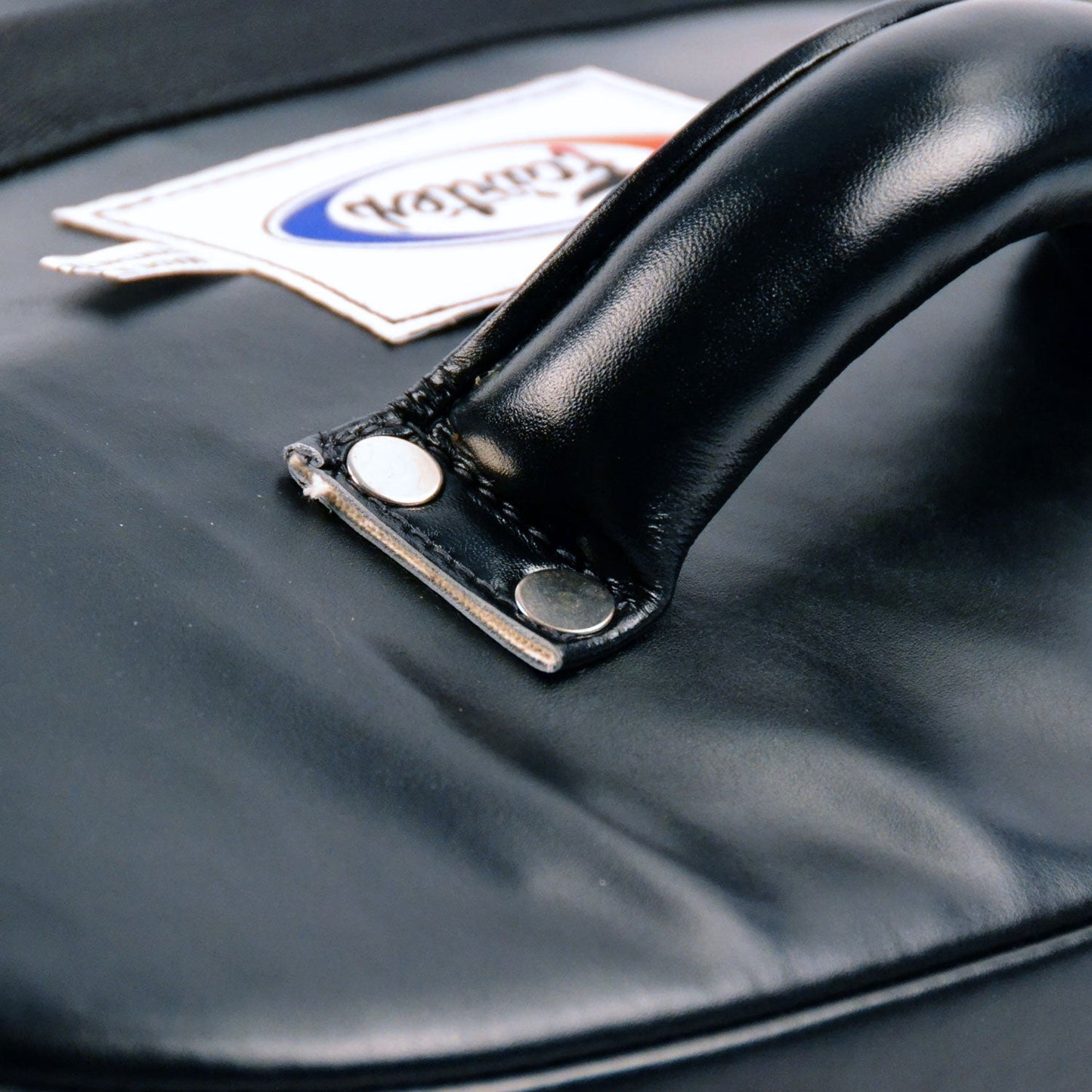 Fairtex FS3 curved kick shield for martial arts training, showing a close-up of the padded, curved surface used for striking practice.