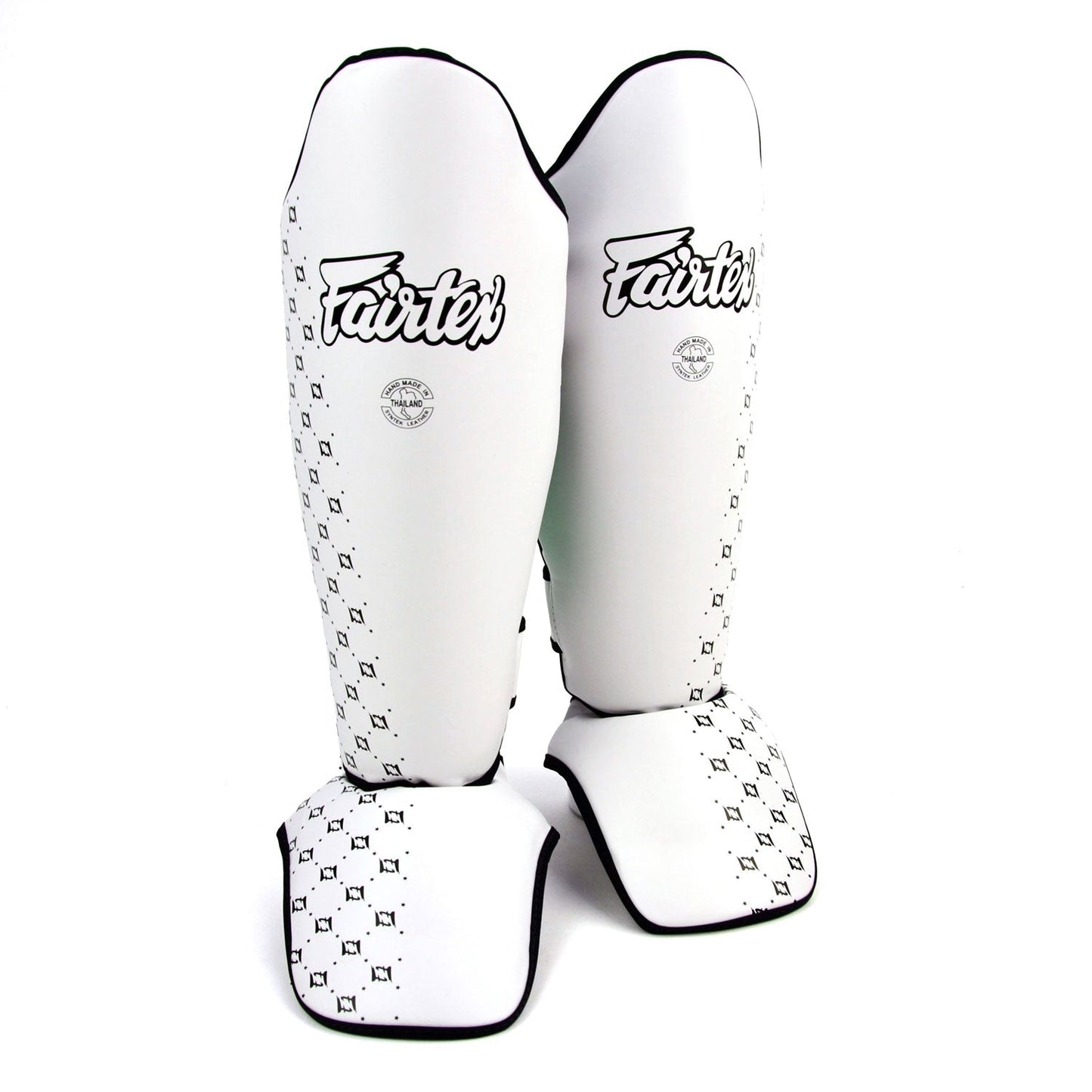 White Fairtex shin pads for martial arts training, featuring padded protection and adjustable straps for a secure fit.