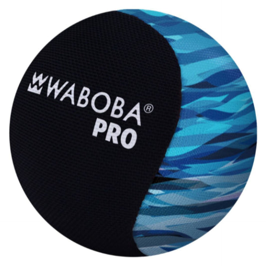 Waboba Pro water bouncing ball for outdoor sports, shown on a sandy beach with blue sky in the background.