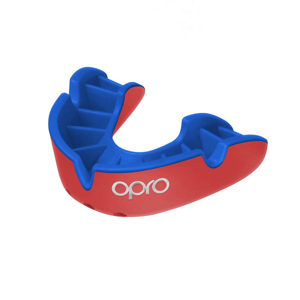 OPRO Silver Self-Fit Mouthguard for sports, molded to fit teeth, in protective sports gear style, with blue and white design.