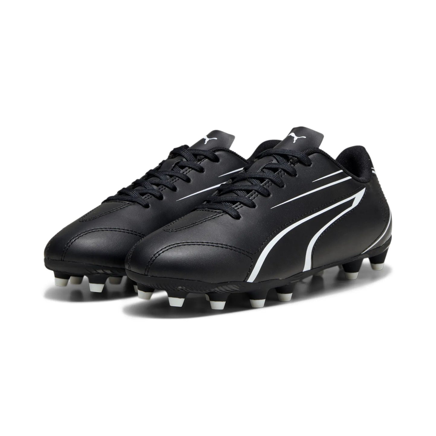 Puma Vitoria FG/AG junior football boots with black and white design, designed for optimal grip and performance on the field.