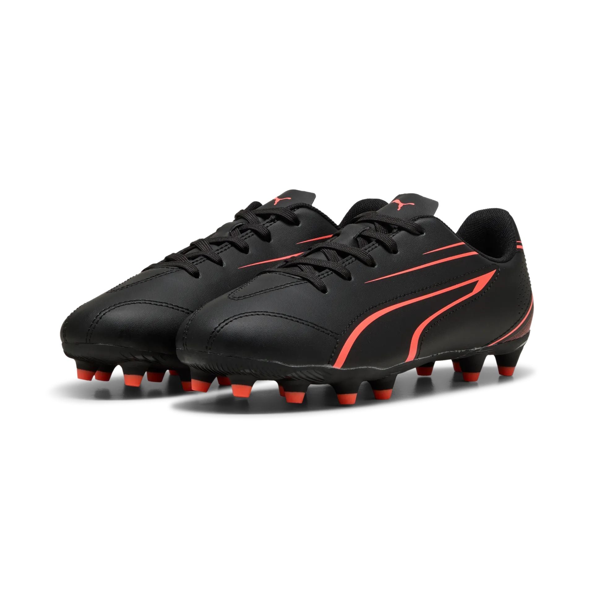 Puma Vitoria FG/AG junior football boots with black and white design, featuring synthetic upper and rubber outsole for turf and grass.