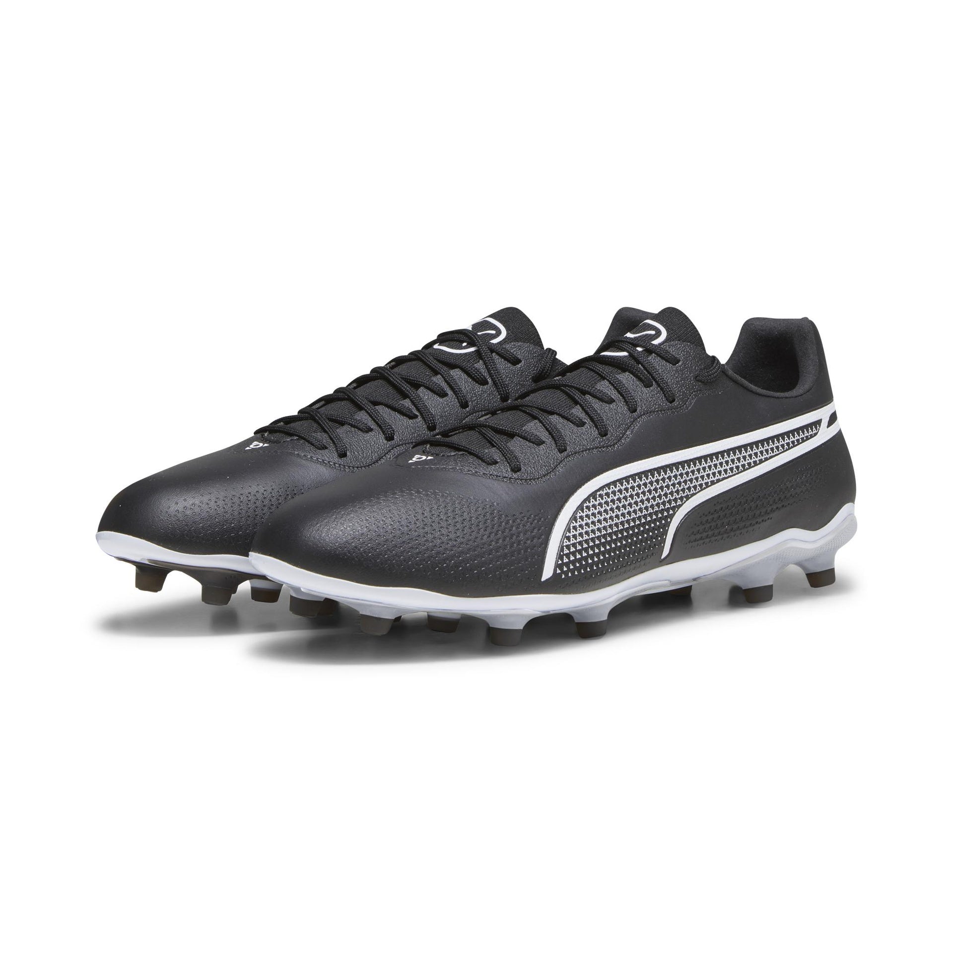 Puma King Pro FG football boots with black and white design, featuring studded soles for firm ground play.