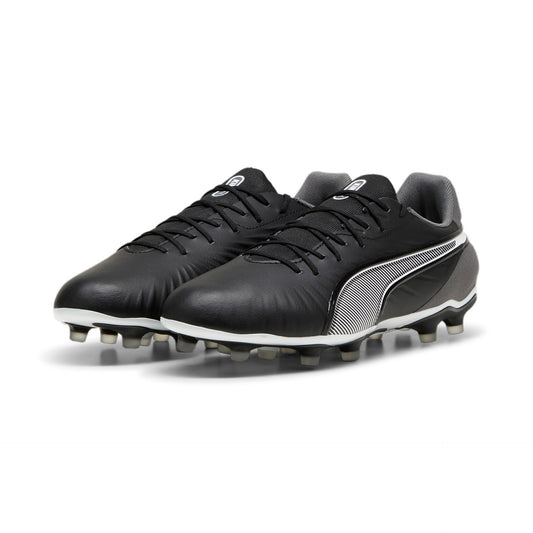 Puma King Match FG/AG football boots with black and white design, featuring synthetic upper and studded sole for firm and artificial ground play.