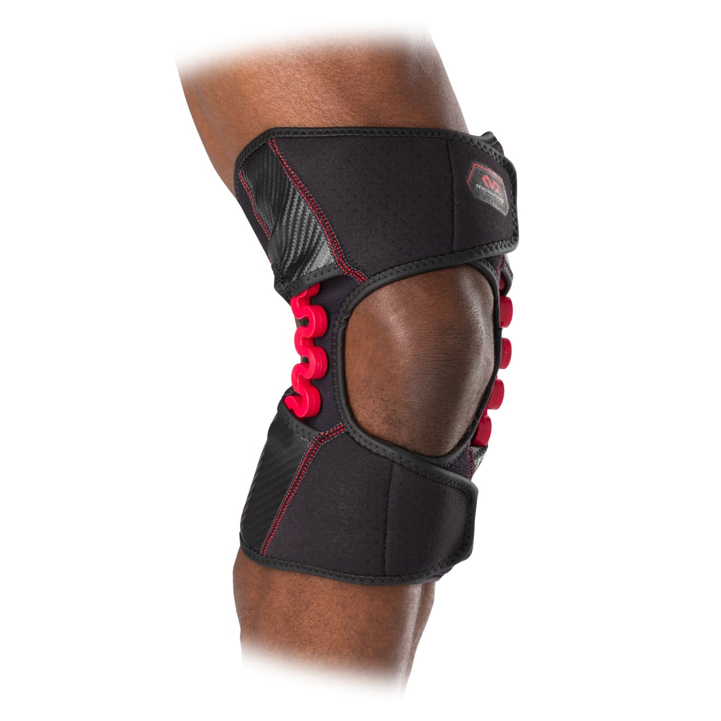 McDavid NRG Knee Over Wrap with Spring Hinge for sport support and stability, shown with adjustable straps and hinge mechanism.