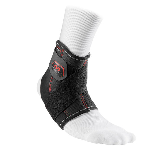 Black McDavid ankle support with strap, featuring adjustable design and compression for sports injury recovery and ankle stability.