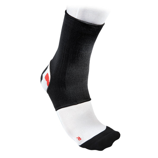 Black McDavid 2-Way Elastic Ankle Sleeve providing support and compression, shown on a person's ankle.