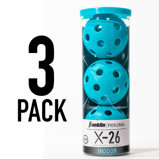 Franklin X-26 indoor pickleball balls, 3-pack, sporting goods, white plastic balls with green and yellow markings on a court.