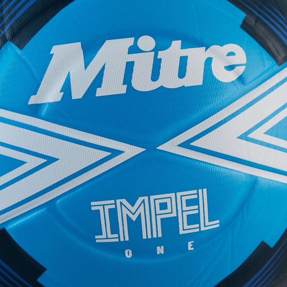 Mitre Impel One football on grass astro surface, sports ball designed for enhanced durability and high-performance play.
