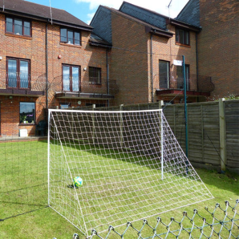 OpenGoaaal! football goal with backstop netting and rebounder, suitable for outdoor soccer practice and training.
