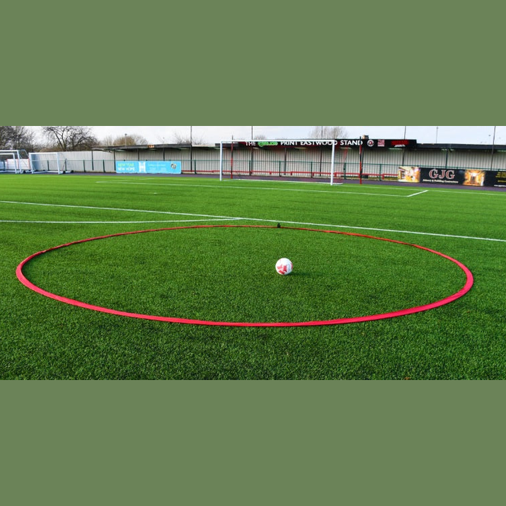 Precision Tiki Taka Football Training Ring 20ft laid flat on grass, showcasing its bright orange color and durable sports training material.