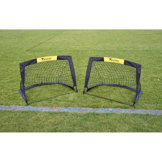 Pair of Precision Fold-a-Goal soccer goals set up on a field, showcasing portable sporting goods for soccer practice and games.