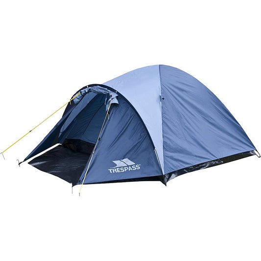 Four-person Trespass Ghabhar tent set up outdoors showing its rainfly, entrance, and ventilation windows in a scenic camping area.