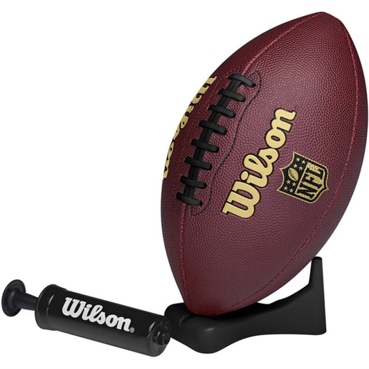 Wilson NFL Ignition football with pump and tee, showing a brown leather American football with white laces and brand logo.