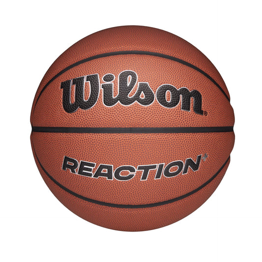 Wilson Reaction Plus basketball showing textured orange surface and black Wilson logo on a sporting goods court.