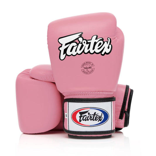 Fairtex BGV1 pink universal boxing gloves, sporting goods, with padded wrist support and vibrant pink color for boxing training.