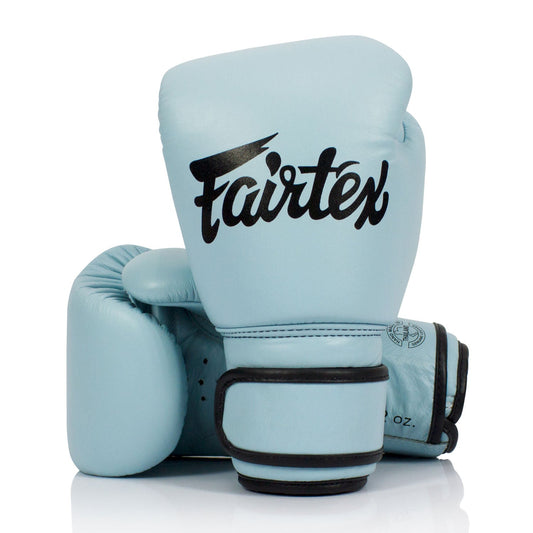 Fairtex BGV20 leather boxing gloves in pastel blue with padding and wrist support, designed for training and sparring.
