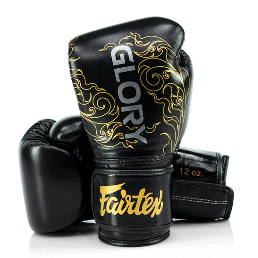 Fairtex X Glory black and gold velcro boxing gloves with padded wrist support and branding, designed for training and competition.