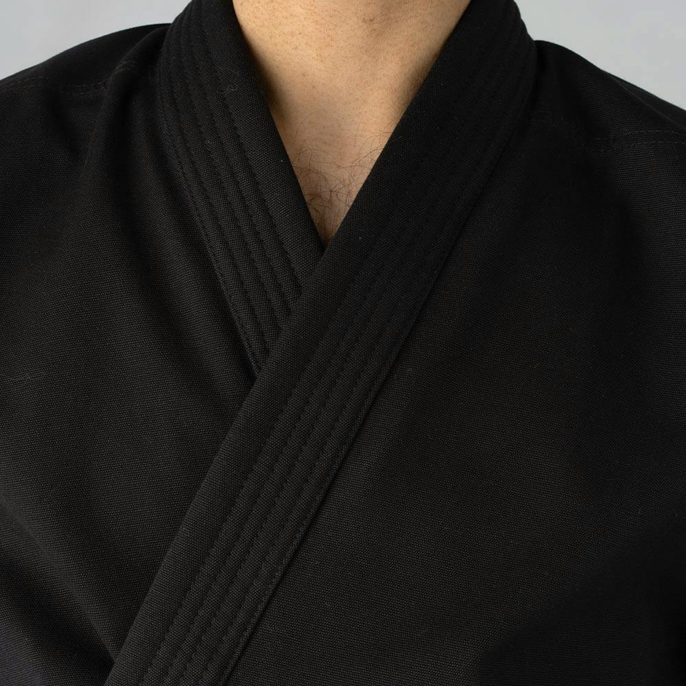 Black Blitz Zanshin Karate Gi for adults, 12oz woven cotton training uniform with jacket and pants, suitable for martial arts practice.
