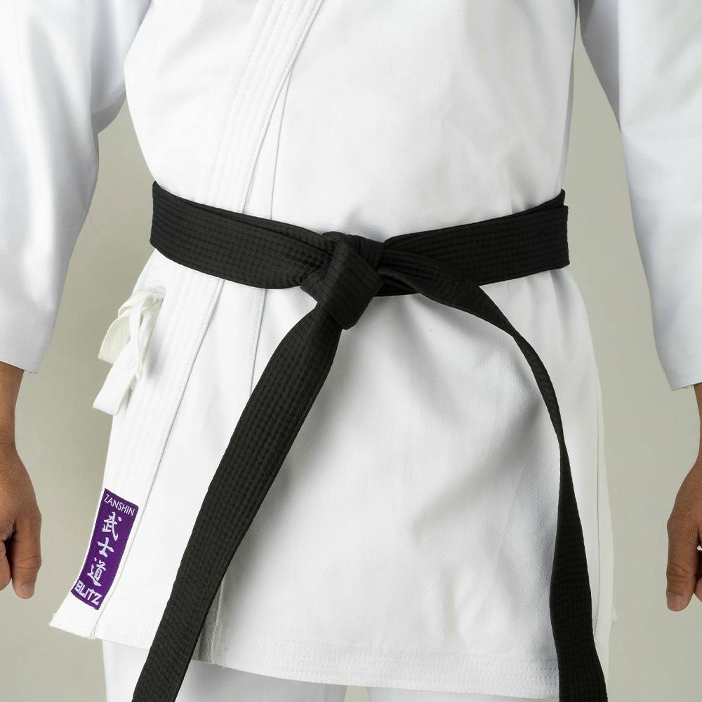 White Blitz Adult Zanshin Karate Gi made of 12oz woven cotton for training, featuring a traditional karate uniform design.