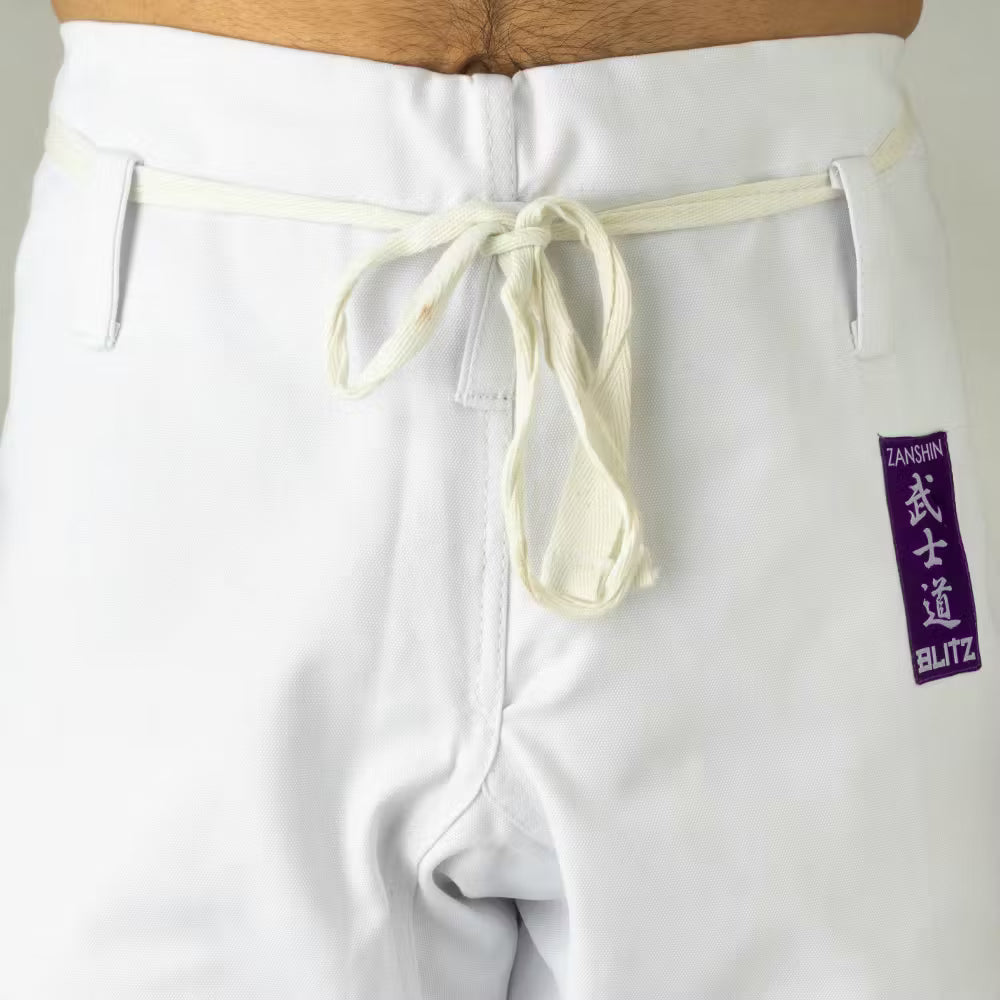 White Blitz Adult Zanshin Karate Gi made of 12oz woven cotton, featuring a traditional martial arts uniform with a clean, durable design.