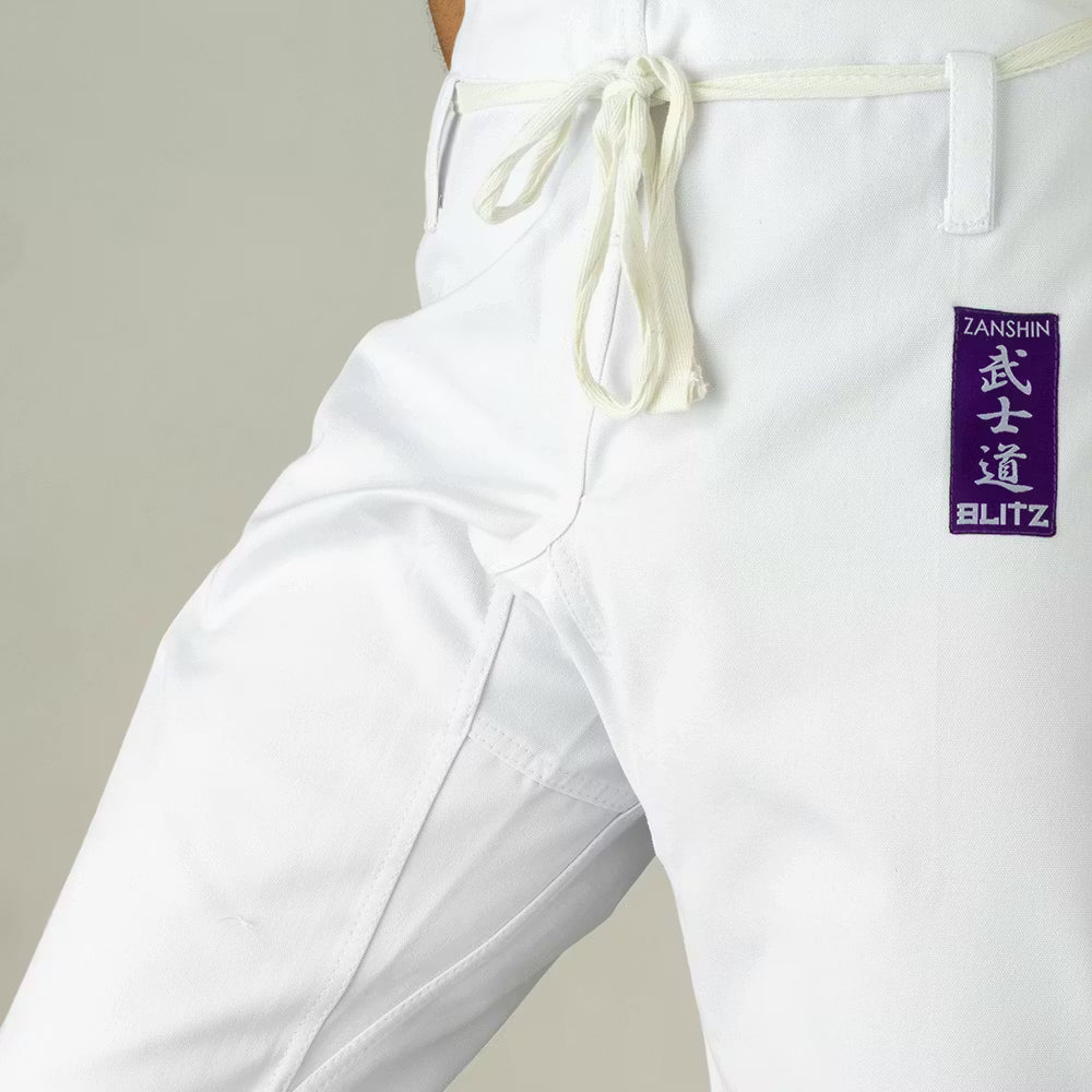 Blitz Adult Zanshin Karate Gi 12oz woven cotton training uniform, white karate suit with reinforced stitching for martial arts practice.