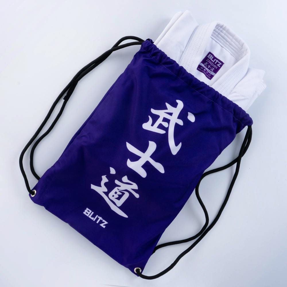 White Blitz Adult Zanshin Karate Gi made of 12oz woven cotton with traditional training design, suitable for martial arts practice.