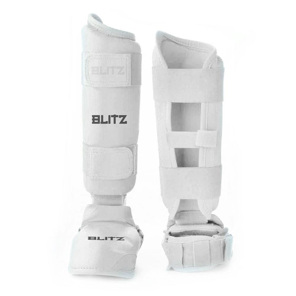White Blitz Elite Karate shin guards with removable foot protection, designed for premium support and impact absorption.