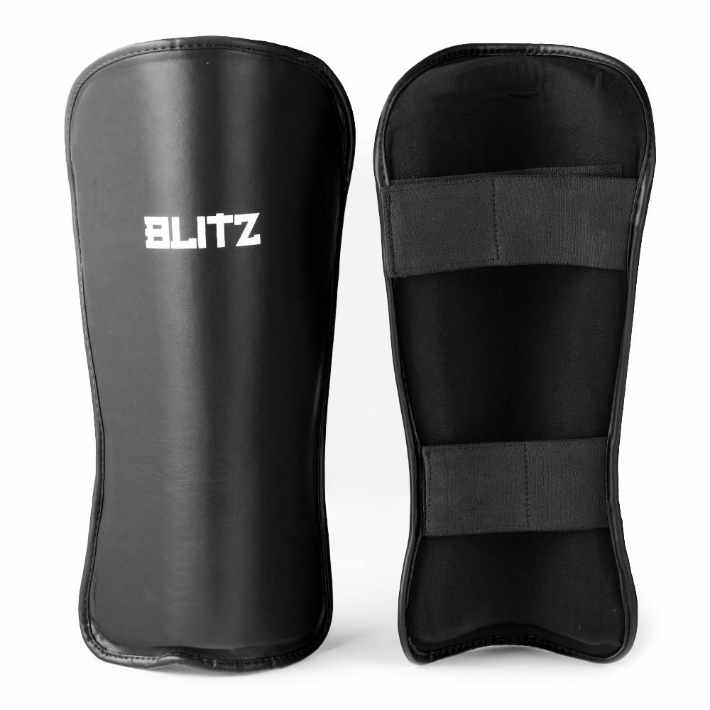 Black Blitz Fusion shin guards with high-density foam padding for secure protection during sports and athletic activities.