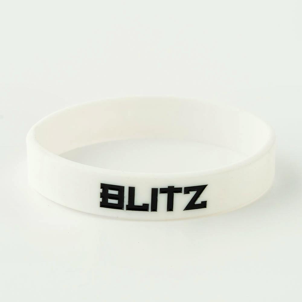 White Blitz Grading Wrist Band displaying belt grade, worn on the wrist, as an accessory for martial arts or grading events.