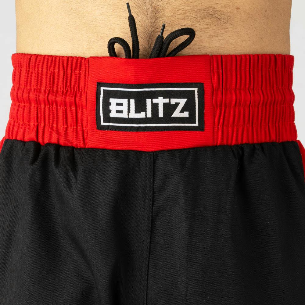 Black and red Blitz Kids Defiant Kickboxing Trousers for youth training, made of polycotton with a comfortable fit.