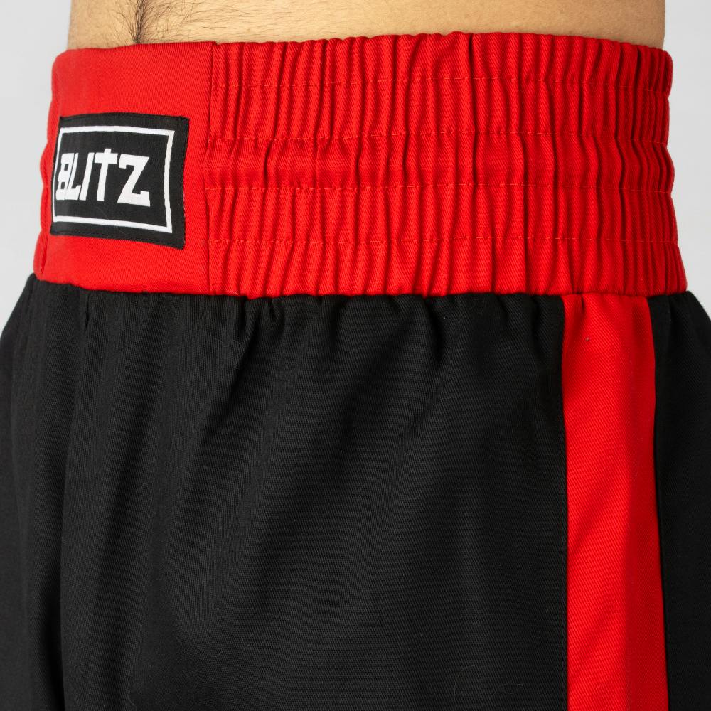 Black and red Blitz Kids Defiant Kickboxing Trousers for youth training, made of polycotton fabric with athletic fit.