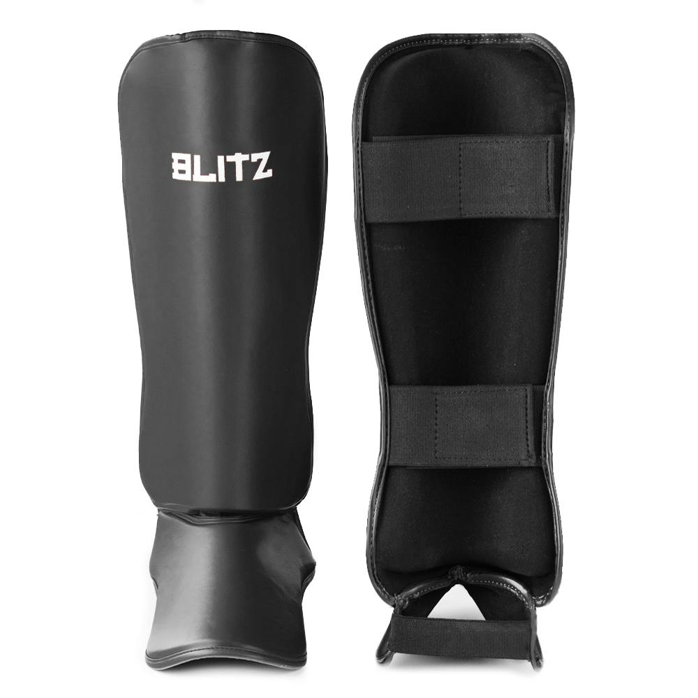 Black Blitz Nitro shin guards offering protective coverage for soccer or football players, featuring a secure strap system.