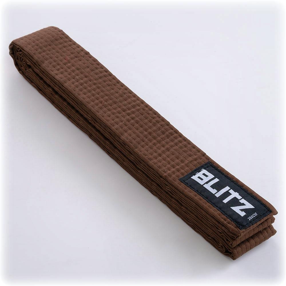 Brown Blitz plain colored martial arts belt folded with branding tag, made of durable fabric for martial arts training and competition.