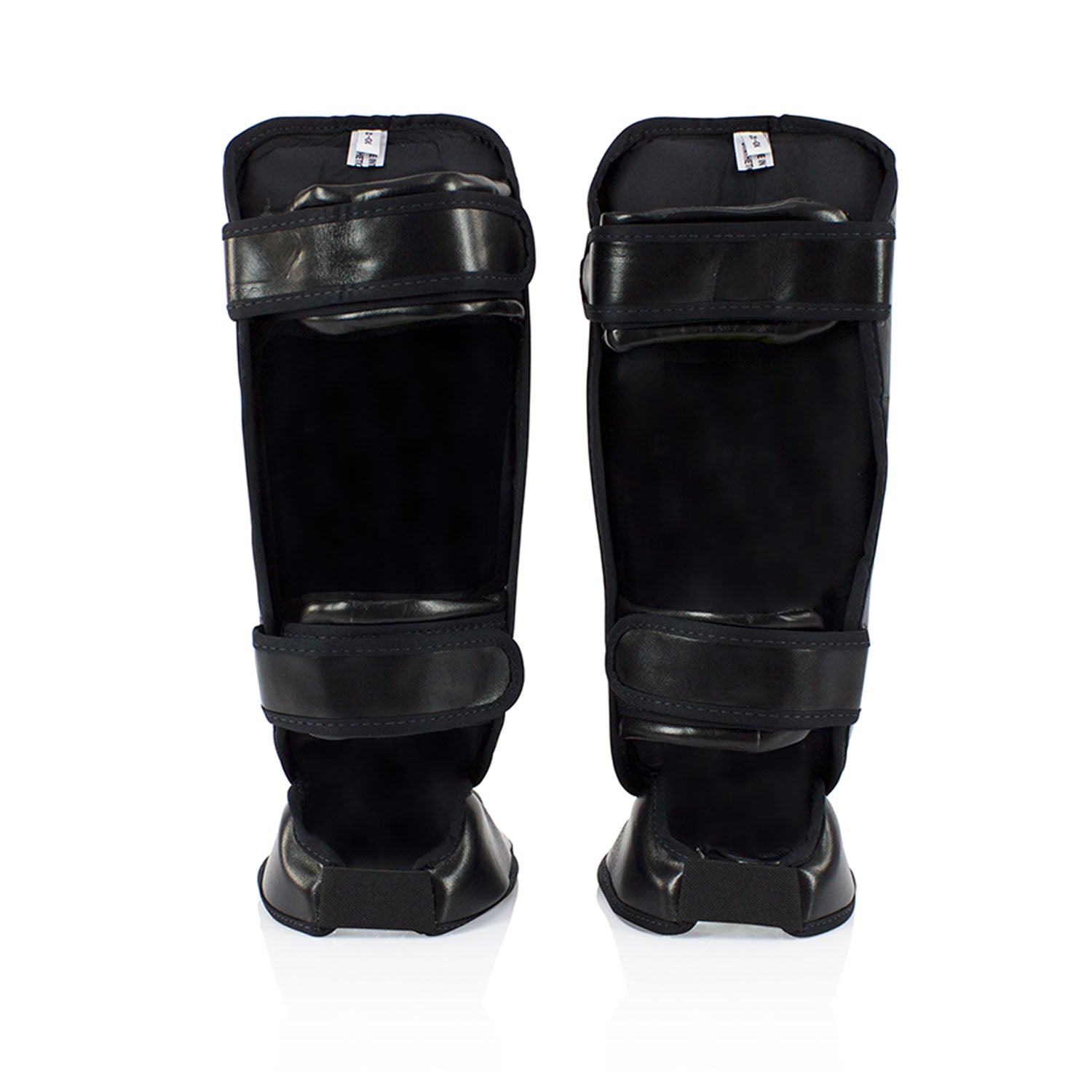 Fairtex SPK9 kids shin pads in black, padded protective sporting gear for youth martial arts or boxing training.
