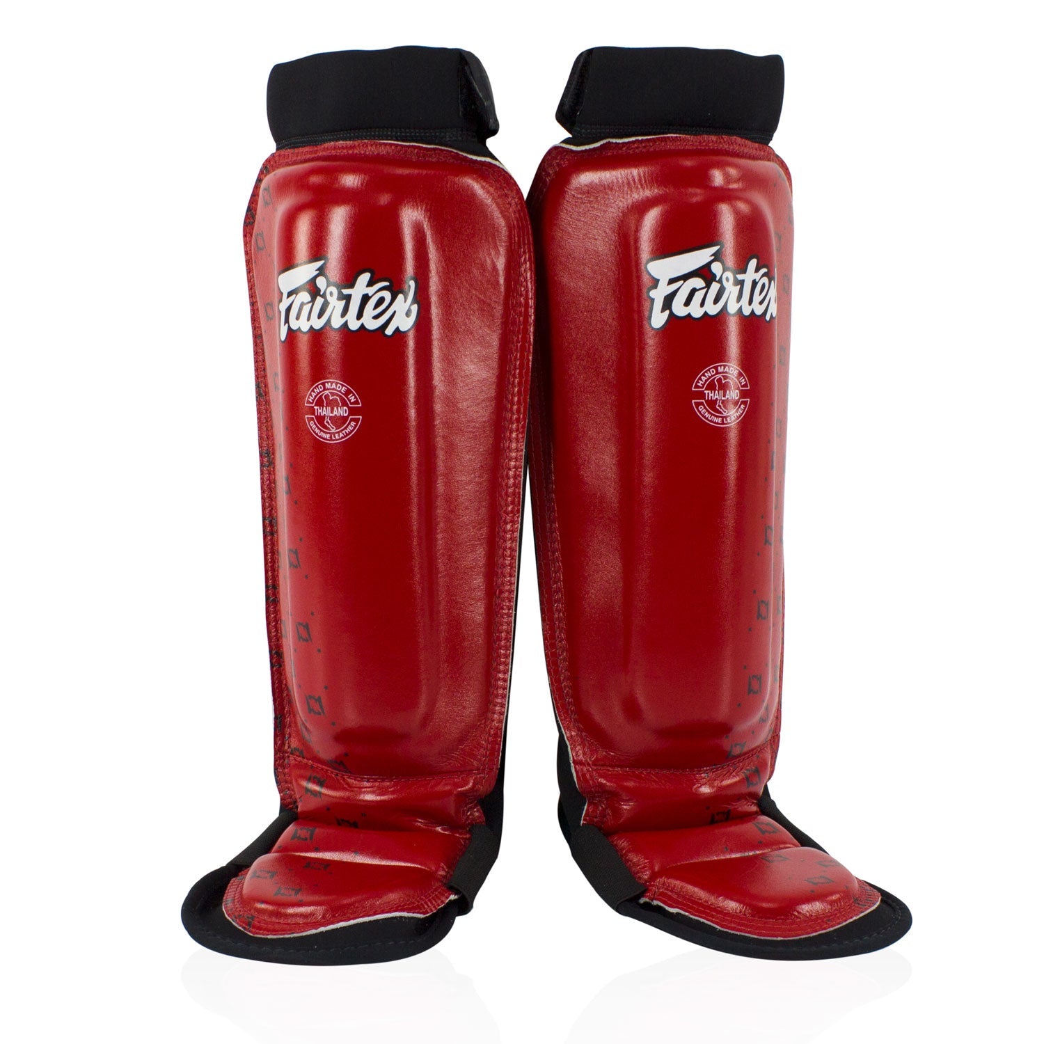 Fairtex red neoprene MMA shin pads with protective padding, designed for combat sports training and martial arts practice.