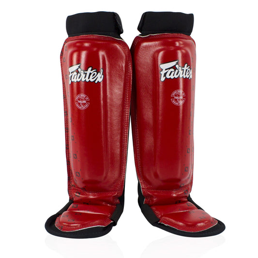 Fairtex red neoprene MMA shin pads with protective padding, designed for combat sports training and martial arts practice.