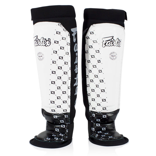 Fairtex neoprene MMA shin pads in white and black with padded protection for martial arts training.