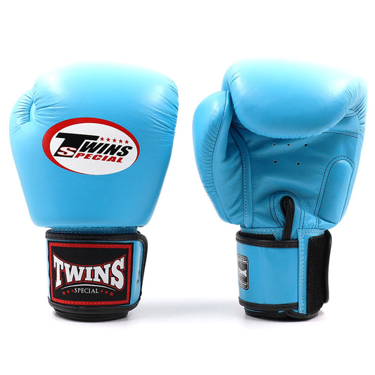 Light blue Twins Special BGVL3 boxing gloves shown in a close-up view, highlighting the padded design and brand logo.